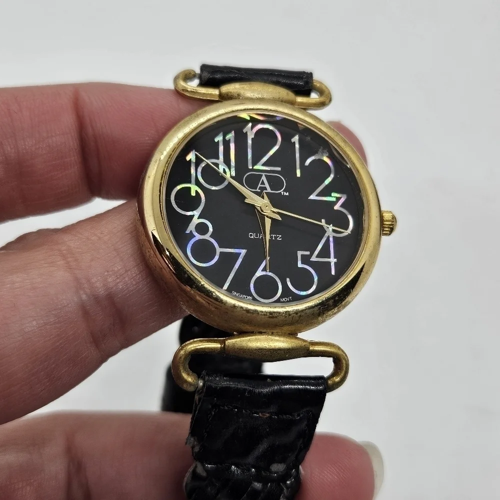 vintage Avenue by Design black and gold tone watch with iridescent digits